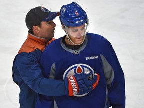 Assistant coach Jay Woodcroft chats with Oilers defenceman Mark Fayne at the end of practice at Rogers Place in Edmonton, Tuesday, November 22, 2016.
