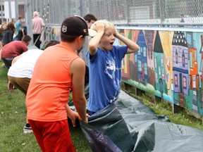 One youth couldn't contain his excitement as children unveiled a new Canada 150 mural at the Ellingson Park skating rink at 6510 111 St. in Edmonton, Alta. on Saturday, Sept. 9, 2017.