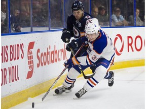 Winnipeg Jets Francis Beauvillier (left) tries to check Edmonton Oilers Davis Koch off the puck during NHL preseason hockey action at the Young Stars Classic held at the South Okanagan Events Centre in Penticton, BC, September, 9, 2017.