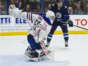 Edmonton Oilers goalie Stuart Skinner slides across his crease during NHL preseason hockey action against the Winnipeg Jets at the Young Stars Classic held at the South Okanagan Events Centre in Penticton, BC, September, 9, 2017.