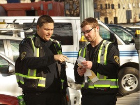 A young parking patrol officers learns on the job in 2014. New technology will eliminate the downtown foot patrol. They'll be redeployed to other hotspots in the city.