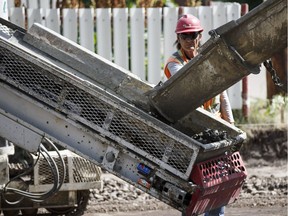 Construction crews work to lay curb on 112 Avenue near 64 Street in Edmonton, Alta. File photo.