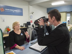 Four Directions financial manager Margaret Archibald helps Bryan Kenny with his retinal scan to access his account.  A new partnership between ATB Financial and Boyle Street Community Services is providing better banking access through a unique community agency called Four Directions Financial. It uses biometric identification technology to make banking more accessible, a first for Alberta. Sept. 25, 2017.