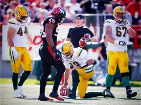 Edmonton Eskimos quarterback Mike Reilly after being knocked to turf by Calgary Stampeders defence during CFL football on Monday, September 4, 2017.