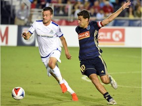 FC Edmonton midfielder Ben McKendry, left, plays the ball in front of North Carolina FC midfielder Nazmi Albadawi in North American Soccer League play at WakeMed Soccer Park in Cary, North Carolina on Saturday, Sept. 2, 2017.