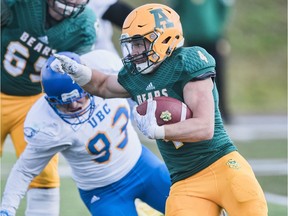 University of Alberta Golden Bears running back Edward Ilnicki avoids a tackle from UBC defensive lineman Nico Repole during a Canada West football game at Foote Field on Saturday, Sept. 23, 2017.