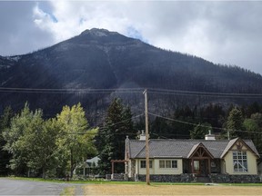 Houses are dwarfed by a burned mountainside in Waterton Lakes, Alta., Wednesday, Sept. 20, 2017. The townsite, which is inside Waterton National Park, was evacuated on Sept. 8 due to the Kenow wildfire.THE CANADIAN PRESS/Jeff McIntosh ORG XMIT: JMC108 Jeff McIntosh,