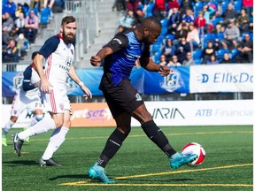 FC Edmonton midfielder Sainey Nyassi, right, takes a shot and goes on to score, with Indy Eleven defender Colin Falvey looking on in North American Soccer League play at Clarke Stadium in Edmonton on Sunday, Sept. 17, 2017.