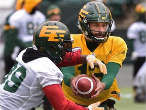 Eskimos quarterback Mike Reilly hands off the ball to running back C.J. Gable during practice at Commonwealth Stadium in Edmonton, October 25, 2017.