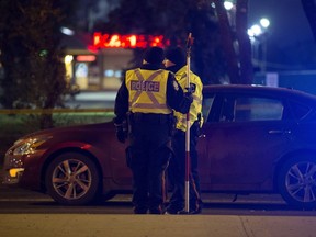 Police work at the scene of a collision involving a car and a pedestrian along 87 Avenue at 169 Street in Edmonton on Wednesday, Oct. 11, 2017.