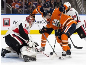 The Edmonton Oilers Kailer Yamamoto (56) and Kris Russell (4) are stopped by the Ottawa Senators' goalie Mike Condon (1) during first period NHL action at Rogers Place on Saturday, Oct. 14, 2017.