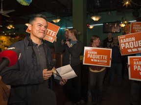 Aaron Paquette poses with the murals he painted at the Grandin LRT station in Edmonton, Alta., on Friday, March 21, 2014.