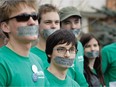 Herman Cortes, second from left and in focus, participates in the Day of Silence at the University of Alberta on April 2014, which brings awareness to the silencing effects of anti-LGBTQ name-calling, bullying and harassment, by wearing duct tape over his mouth.