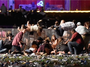 People scramble for shelter at the Route 91 Harvest country music festival after gunman Stephen Paddock launched a killing spree. At least 58 died and more than 500 more were wounded. It was the most deadly mass shooting in American history - but police said Paddock was not a terrorist.