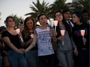 LAS VEGAS, NV - OCTOBER 2: Mourners attend a candlelight vigil at the corner of Sahara Avenue and Las Vegas Boulevard  for the victims of Sunday night's mass shooting, October 2, 2017 in Las Vegas, Nevada. Late Sunday night, a lone gunman killed more than 50 people and injured more than 500 people after he opened fire on a large crowd at the Route 91 Harvest Festival, a three-day country music festival. The massacre is one of the deadliest mass shooting events in U.S. history.