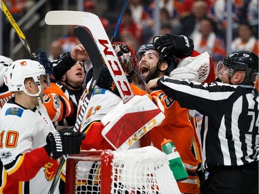 Edmonton Oilers forward Patrick Maroon exchanges words with Calgary Flames goalie Mike Smith during NHL action on Oct. 4, 2017, at Edmonton's Rogers Place.