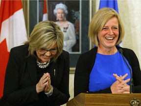 Former Alberta Progressive Conservative leadership candidate Sandra Jansen, left, and Alberta Premier Rachel Notley share a joke after the swearing-in ceremony at Government House in Edmonton on Tuesday, Oct. 17, 2017 where Jansen was appointed Alberta minister of infrastructure in Notley's NDP government.