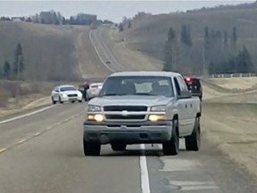 Dashboard camera footage recorded by witness Tomasz Gorny captures a vehicle fleeing from police in a hail of RCMP gunfire around 4:25 p.m. on Friday, Oct. 13, 2017, on Aspelund Road north of Sylvan Lake, Alta.