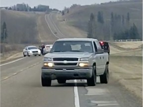 Dashboard camera footage recorded by witness Tomasz Gorny captures a vehicle fleeing from police in a hail of RCMP gunfire around 4:25 p.m. on Friday, Oct. 13, 2017, on Aspelund Road north of Sylvan Lake, Alta.