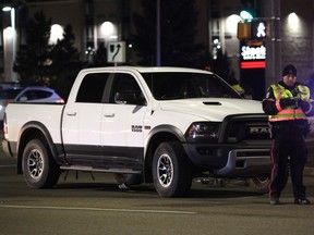 Edmonton Police Service officers investigate a collision between a truck and a pedestrian at 178 Street and 100 Avenue on Friday, October 14, 2017.