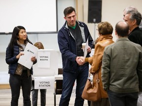 Edmonton incumbent mayor Don Iveson speaks to other voters while waiting to have his vote tabulated on election day at McKernan Baptist Church on Oct. 16, 2017.