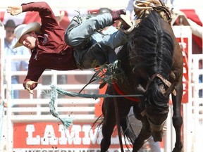 Jacobs Crawley from College Station, Texas, gets tossed riding Crazy Day Job during the Calgary Stampede Saddle Bronc Championship on July 9, 2012.