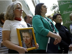 Petra Schulz (left) holds a photograph of her son Danny, who died from a fentanyl overdose. Beside her is Alberta Associate Minister of Health Brandy Payne and Alberta Health Services president & CEO Dr. Verna Yiu (right). The government of Alberta announced at the Royal Alexandra Hospital in Edmonton on October 18, 2017 that the first cities in Alberta to have supervised consumption services for people at risk of overdosing from drugs will be Edmonton and Lethbridge.