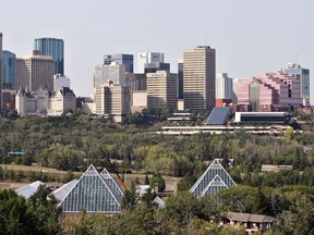 The Muttart Conservatory's four glass pyramids rise from Edmonton's river valley, housing plant species from around the world.