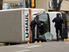 Edmonton police investigate a U-Haul truck flipped on its side during a police pursuit on Sept. 30, 2017.