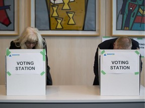 People take part in advance voting in the Heritage Room at City Hall voting stations on Friday Oct. 13, 2017 in Edmonton. File photo.