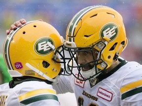 Edmonton Eskimos quarterback Mike Reilly, right, celebrates with teammate C.J. Gable following a touchdown during first half CFL football action against the Montreal Alouettes in Montreal, Monday, October 9, 2017.