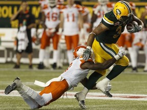 Edmonton's Calvin McCarty (31) is stopped by BC's Buddy Jackson (3) during the second half of a CFL game between the Edmonton Eskimos and the BC Lions at Commonwealth Stadium in Edmonton on Friday, July 28, 2017.