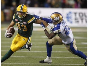 Winnipeg Blue Bombers' TJ Heath (23) tackles Edmonton Eskimos Brandon Zylstra (83) during first half CFL action in Edmonton, Alta., on Saturday September 30, 2017.