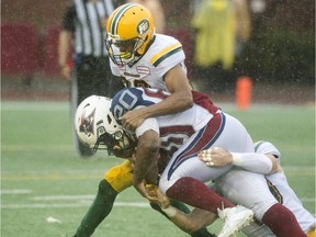 Montreal Alouettes running back Tyrell Sutton is tackled by Edmonton Eskimos' defenders during CFL action on Oct. 9, 2017, in Montreal.