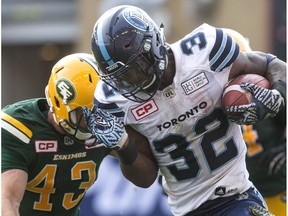 Toronto Argonauts running back James Wilder Jr. (right) is tackled by Edmonton Eskimos defensive back Neil King during the first half of CFL football action in Toronto on September 16, 2017.