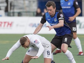 FC Edmonton's Nik Ledgerwood watches as Jacksonville Armada  Jake Black falls at Clarke Park, in Edmonton April 8, 2017.