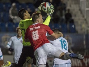 Albert Watson of FC Edmonton, is late to the ball as keeper Daniel Vega of Miami FC make the save in the first half at Clark Field on October 21, 2017.