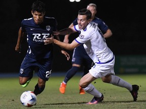 FC Edmonton midfielder Ben Fisk, right, tries to stop Jacksonville Armada defender Bryam Rebellon in North American Soccer League play at Hodges Stadium UNF in Jacksonville, Florida on Wednesday, Oct. 18, 2017.