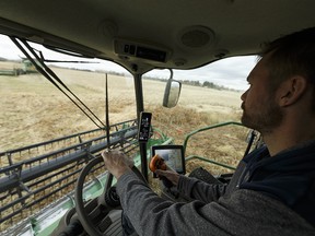 Dave Vander Heide brings in canola behind the wheel of his combine as part of a team of volunteers working with Share the Harvest and the Canadian Foodgrains Bank in a field east of Gibbons, Alberta on Saturday, October 7, 2017. Proceeds from crop sales provide food and farming assistance to people facing poverty around the world. Ian Kucerak / Postmedia