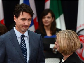 Prime Minister Justin Trudeau talks with Alberta Premier Rachel Notley as they arrive to meet with first ministers and national indigenous leaders during the First Ministers Meeting in Ottawa on Tuesday, Oct. 3, 2017.