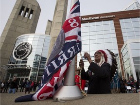Grand Chief Willie Littlechild raises the Treaty 6  flag at MacEwan University on its City Centre Campus during a ceremony that paid  tribute to the Indigenous groups, including the Plains, Woodland Cree, Nakota, Saulteaux, Dene and Métis peoples on Wednesday, Oct. 18, 2017, in Edmonton.