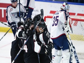 Brayden Watts (No. 34) of the Vancouver Giants celebrates his goal against goaltender Beck Warm of the Tri-City Americans with teammates during the first period of their WHL game at the Langley Events Centre Friday.