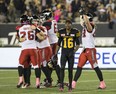Hamilton Tiger-Cats wide receiver Brandon Banks walks away in defeat as the Calgary Stampeders celebrate their game-winning field goal in Hamilton on Oct. 13, 2017.