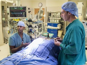 Dr. Jeevan Nagendran, a cardiac surgeon at the Mazankowski Alberta Heart Institute, in an operating room talking about a minimally invasive heart surgery program, enabling cardiac surgeons to avoid opening the chest when performing major, open-heart surgery on hundreds of patients each year, on Oct. 12, 2017.  Beside him is registered nurse Darren Melby.