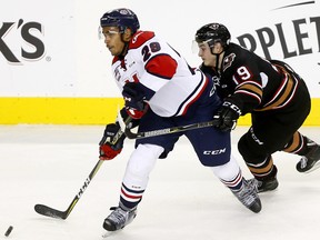 Calgary Hitmen Andrei Grishakov battles Lethbridge Hurricanes Lethbridge Hurricanes player Koletrane Wilson tries to get a shot away against the host Calgary Hitmen during second-period action at the Scotiabank Saddledome in Calgary on Sunday, October 15, 2017.