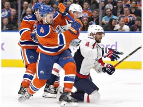 Washington Capitals' Alex Ovechkin (8) is taken down by Edmonton Oilers' Kris Russell (4) during third period NHL action in Edmonton, Alta., on Wednesday October 26, 2016.