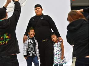 Cennser Brown poses for a portrait with his siblings Rasta (L), 5 and Willa, 4, at the Homeless Connect Edmonton which works with guests experiencing homelessness or at risk of becoming homeless to access essential and dignity-enhancing services, held at the Shaw Conference Centre in Edmonton, October 15, 2017.
