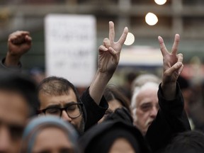 Edmontonians cheer during the Stand Together Against Violence in Solidarity with EPS vigil organized by Alberta Muslim Public Affairs Council at Churchill Square in Edmonton, Alberta after a police officer and four bystanders were injured in a terrorist attack on Sunday, October 1, 2017.