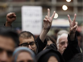 Edmontonians cheer on Sunday, Oct. 1, 2017 during the Stand Together Against Violence in Solidarity with EPS vigil organized by Alberta Muslim Public Affairs Council at Churchill Square in Edmonton, Alberta after a police officer and four bystanders were injured in a terrorist attack.
