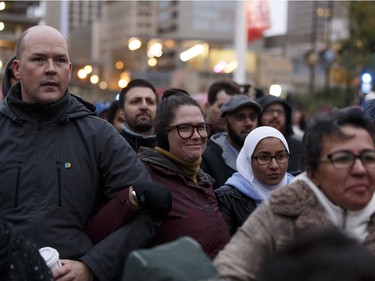 Edmontonians link arms during the Stand Together Against Violence in Solidarity with EPS vigil organized by Alberta Muslim Public Affairs Council at Churchill Square in Edmonton, Alberta after a police officer and four bystanders were injured in a terrorist attack on Sunday, October 1, 2017.